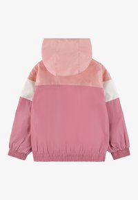 Lätt pink jacka med huva, med en färgblockerad design i olika nyanser av rosa och vitt, elastiska manschetter och fåll.