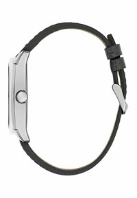 Cassa dell'orologio in metallo tono argento con quadrante rotondo, cinturino in gomma nera e dettagli in metallo argentato. La vista laterale mette in evidenza i dettagli dei pulsanti.