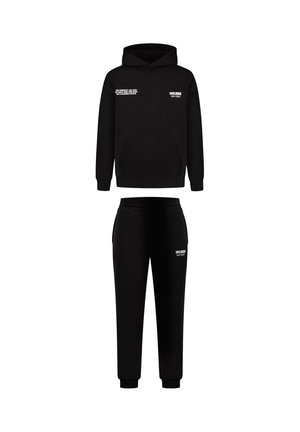 Czarny zestaw bluzy z kapturem i dresów. Bluza ma przednią kieszeń i biały tekst. Miękka tkanina, luźny krój, zwężane spodnie dresowe z elastycznymi mankietami.