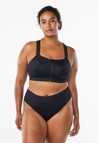 Czarny stanik sportowy z szerokimi ramiączkami i zamkiem z przodu, w po�łączeniu z wysokim bikini. Gładka faktura, minimalna ilość dodatków i zharmonizowany design.
