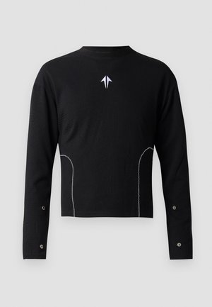 Black long-sleeve shirt with a textured weave, white accent stitching, and a small logo on the chest. Features snap details on sleeves.