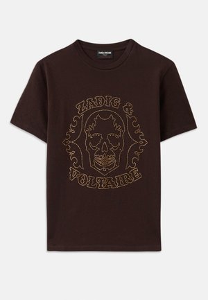 Schwarzes T-Shirt aus Baumwolle mit einem Skelettgrafik, die von goldenen Nieten umrissen ist, mit dem Text "Zadig & Voltaire", kurzen Ärmeln und Rundhalsausschnitt.