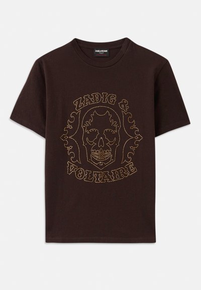 Čierne tričko vyrobené z bavlny, s grafikou lebky orámovanou zlatými cvokmi a textom "Zadig & Voltaire", krátke rukávy a okrúhly výstrih.