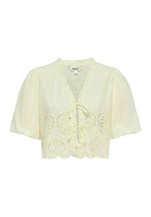 Krótka bluzka z kremowego materiału z falbankowym dekoltem w serek, z przodu zapinana na supełki, z bufkami na rękawach oraz haftem w kształcie serc na ozdobnym wykończeniu u dołu.