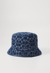 Navy denim bucket hat featuring a patterned design, rounded crown, wide brim, and a small label on the side for brand identification.
