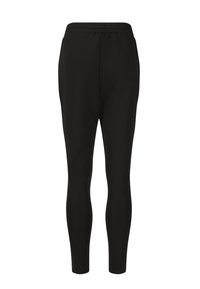 Zwarte legging gemaakt van rekbare stof, met een elastische tailleband, slim fit en een strakke, naadloze ontwerp zonder zichtbare sluitingen.