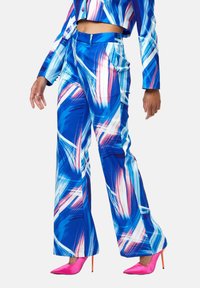 Bright blue pants with abstract white and pink brushstroke patterns. Made of smooth fabric, featuring a fitted design and wide legs.