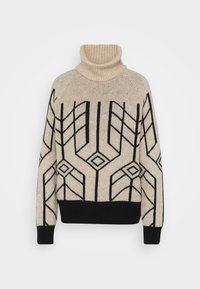 Krämfärgad tröja med ett svart geometriskt mönster, med en ribbad hög hals och kontrasterande muddar och fåll. Tillverkad i ett strukturerat stickat tyg.