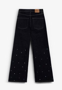 Jeans negros de pierna ancha con un tejido de denim texturizado. Adornados con detalles multicolores en el dobladillo y una etiqueta de cuero en la cintura.