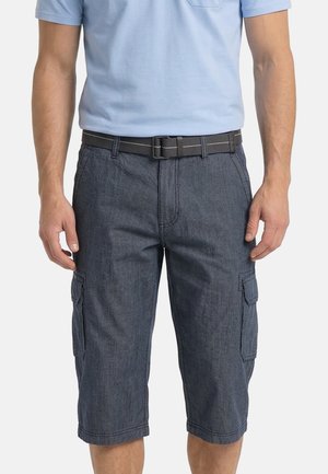 Man wearing mid-length dark gray cargo shorts with side pockets and a light blue short-sleeve shirt tucked in, secured with a black belt.