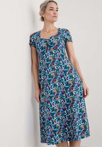 Floral dress made of lightweight fabric, featuring a fitted bodice, short sleeves, and a flared hem with a vibrant blue, purple, and pink pattern.
