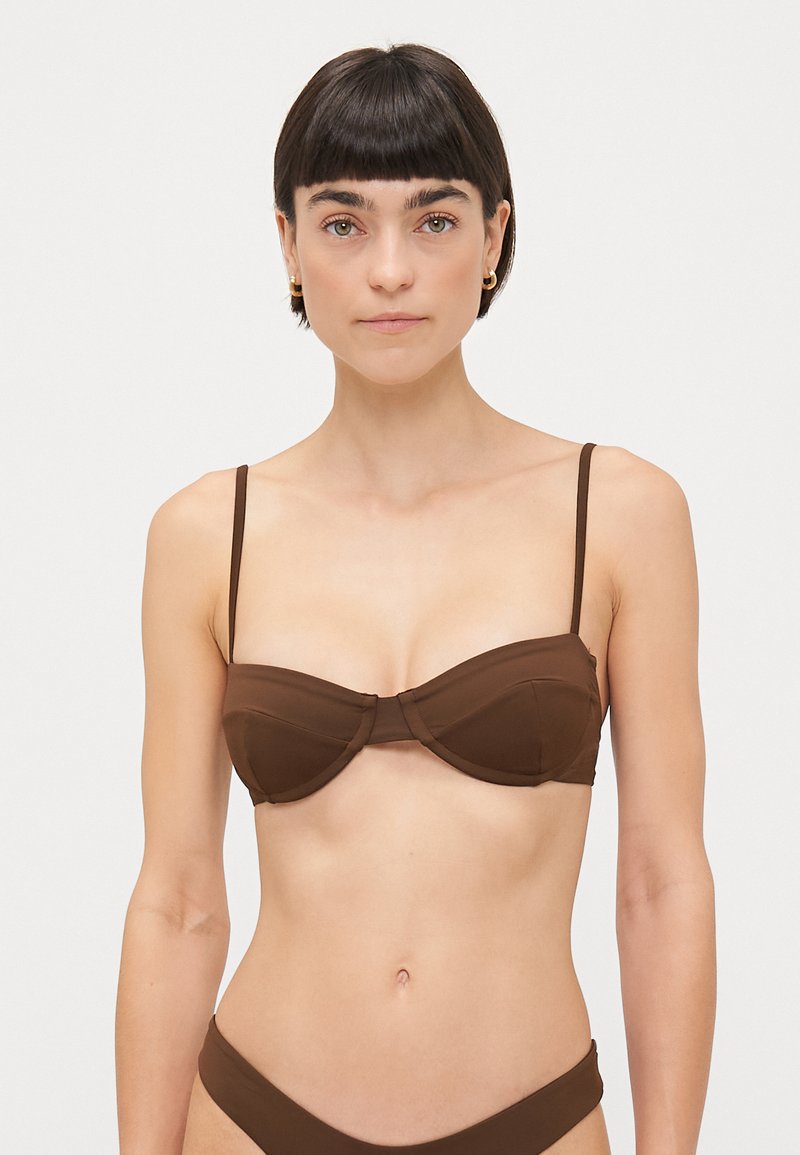 Brown bikini top with underwire support, featuring thin adjustable straps, a molded cup design, and a smooth, matte texture.