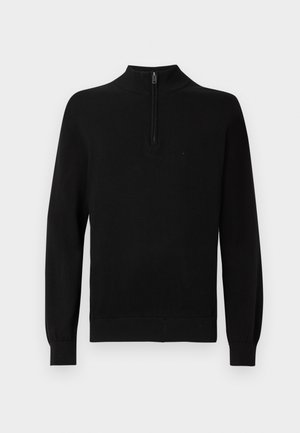 Pull noir en tricot avec un col montant et une courte fermeture éclair. Présente des bords-côtes aux poignets et à l'ourlet, offrant une silhouette ajustée. Texture lisse.