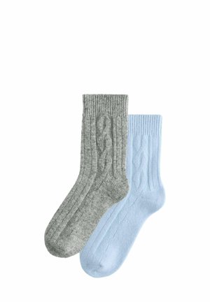 Two pairs of socks: one gray with a ribbed texture and cable knit pattern, the other light blue with a similar ribbed design.
