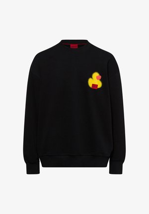 Black sweatshirt made of cotton, featuring a yellow rubber duck graphic and a red logo patch on the chest. Ribbed neckline and cuffs.