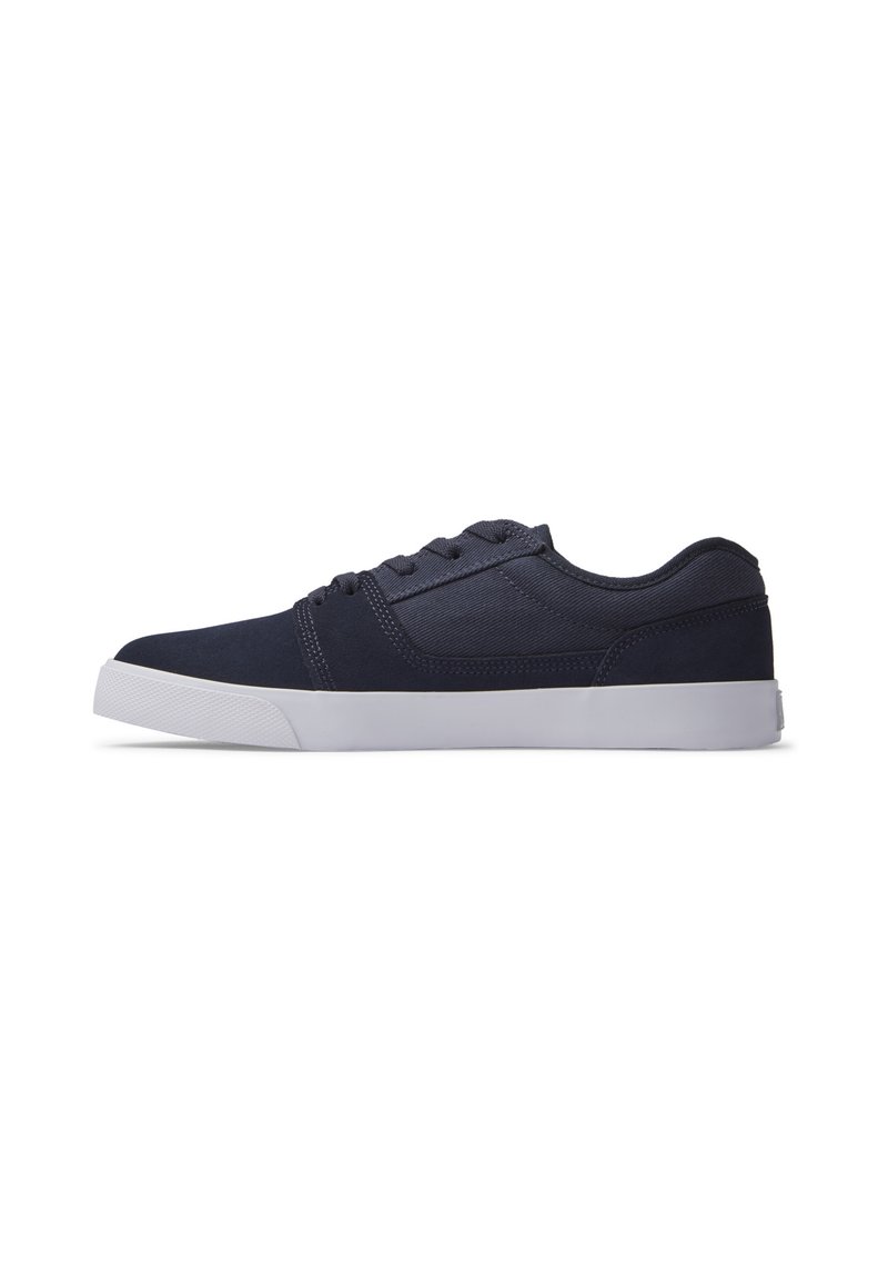 Navy blue sneakers with a smooth fabric upper, lace-up design, padded collar, and white rubber sole featuring a textured grip.