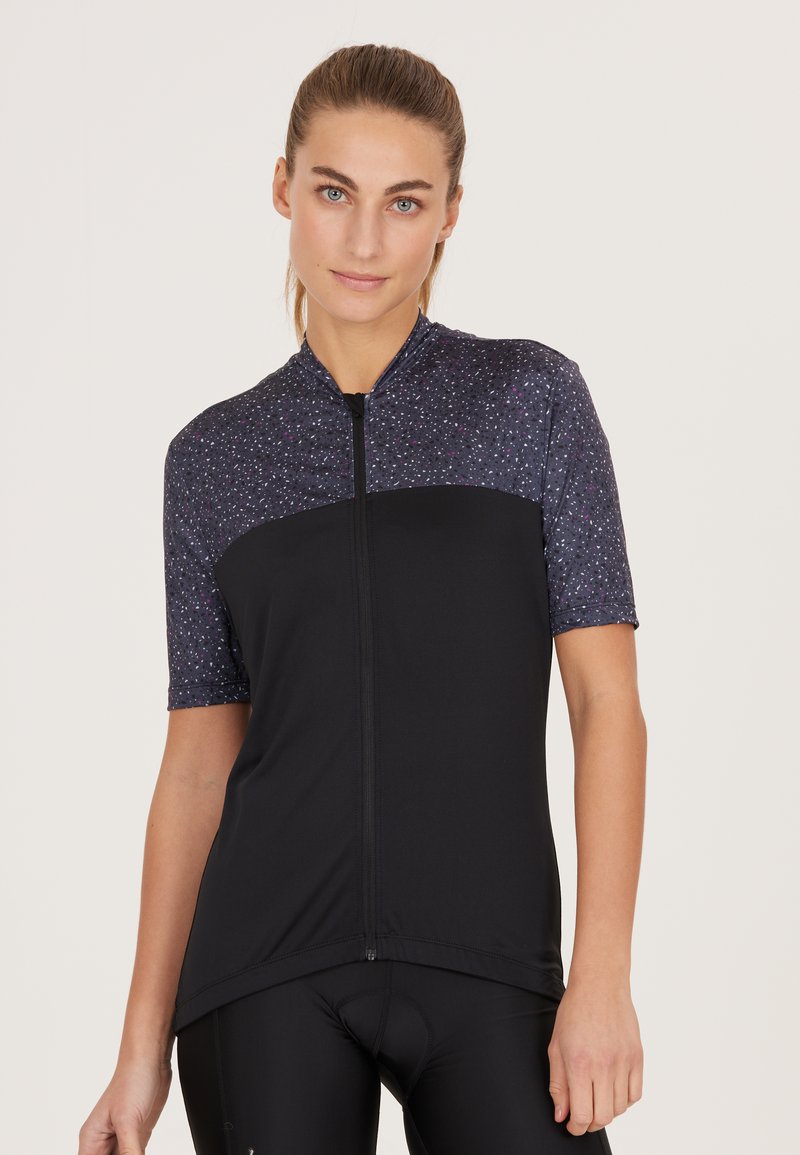 Svart cykeltröja med korta ärmar, med en prickig mörk överdel och dragkedja framtill. Stretchigt tyg med en mjuk textur.