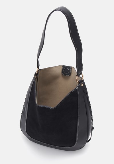 Black suede and leather shoulder bag with a rounded shape, contrast stitching, and a detachable strap. Open interior with a beige lining.
