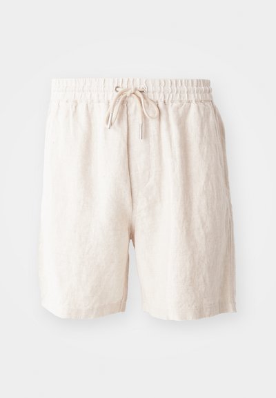 Shorts en lin beige avec une taille élastique, cordon de serrage ajustable et poches latérales. Texture douce avec une coupe décontractée.