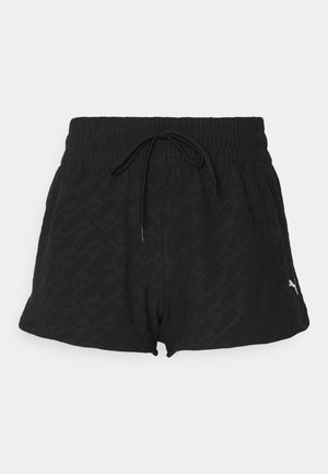 Fekete sportnadrág elasztikus derékpánttal, zsinóros zárással és diszkrét textúrával. Oldalán egy kis fehér logó található.