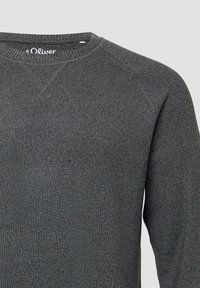 Gray sweater with a crew neckline, textured knit fabric, and raglan sleeves. Features a logo tag at the back.