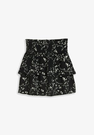 Mini-jupe noire à volants avec imprimé floral blanc et taille élastiquée smockée.