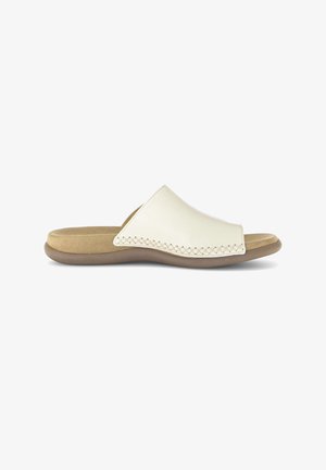 Beige open-toe slide sandal with cushioned insole and wide stitched leather strap over the top, shown from the side.