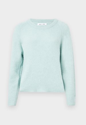 Svijetlo mint zeleni pulover od mekog, teksturiranog materijala. Ima okrugli izrez i rebraste manšete. Klasičan kroj s raglan rukavima.