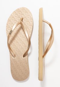 Gold flip-flop with a textured footbed featuring circular patterns. Thin, glossy straps and a durable outsole. Lightweight and flexible design.