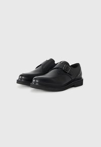 Black leather shoes with a rounded toe, a single buckle strap, and a low rubber sole. Smooth texture with minimal detailing.