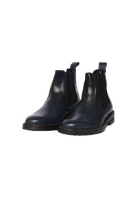 Stivali Chelsea neri in pelle con pannelli laterali elasticizzati, punte arrotondate e linguette. Presentano una suola in gomma nera bassa per il massimo comfort.