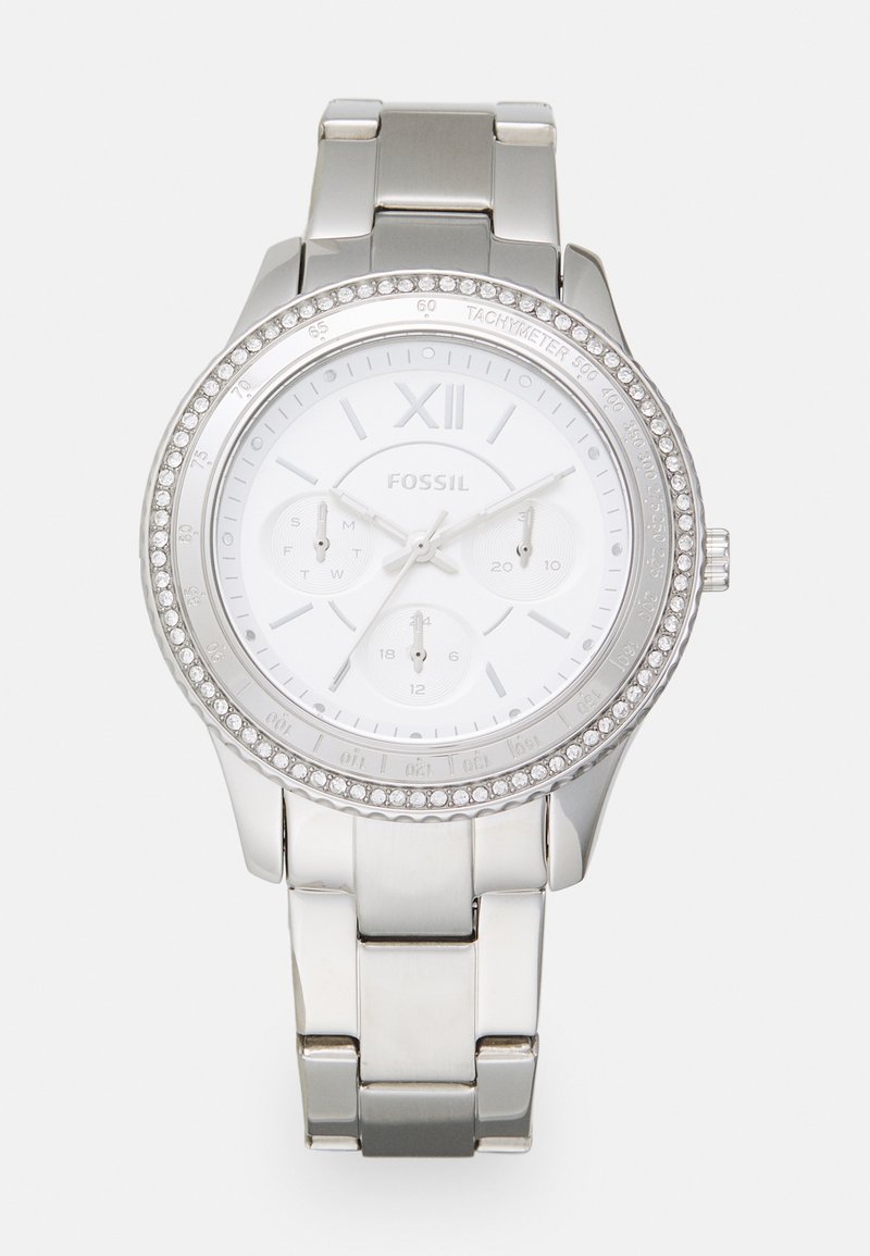 Montre en métal argenté avec un cadran blanc, une lunette ornée de cristaux, trois sous-cadrans et un chiffre romain XII à la position de 12 heures.