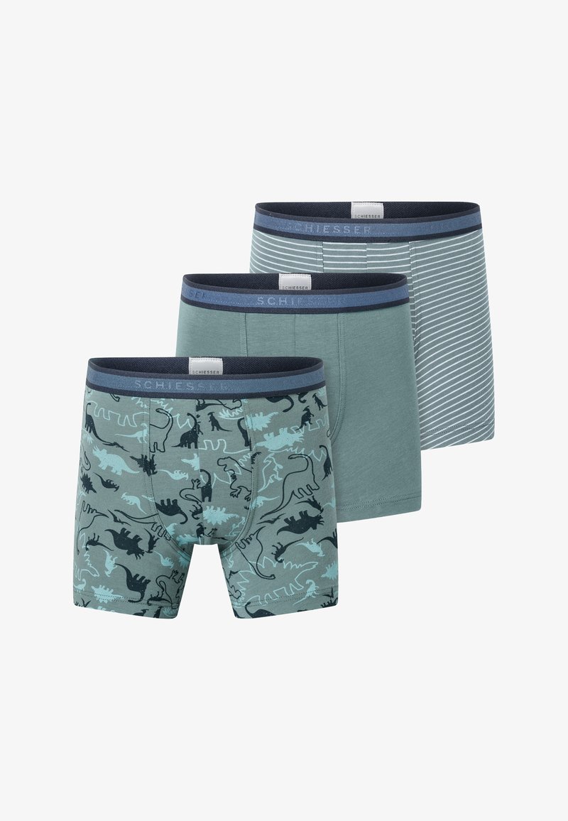 Drei Paar Herrenboxershorts in verschiedenen Designs: eine mit Dinosaurierdruck, eine einfarbig grün und eine blau gestreift, alle mit elastischen Taillengummis.