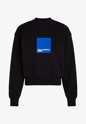 Melnā, īsā kapucīna krekls no mīkstas auduma, ar zilu kvadrātu logotipu un baltu tekstu "KARL LAGERFELD JEANS" uz priekšpuses.