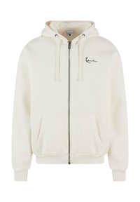 Hettegenser med glidelås i myk, kremfarget stoff med svart logo aksent på brystet. Har en hette med snøring og to frontlommer.