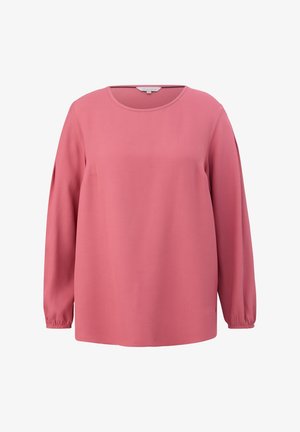Dugih rukava majica od meke ružičaste tkanine, s okruglim izrezom i nabranim manžetama. Jednostavan dizajn s ravnim krojem i bez vidljivih uzoraka.