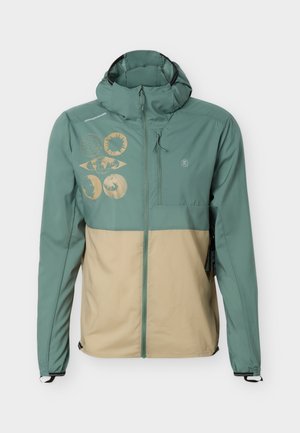 Κουκούλα αντιανεμικό μπουφάν διχρωμίας σε πράσινο και μπεζ με φερμουάρ στο μπροστινό μέρος και χρυστά γεωμετρικά σχέδια ήλιου και φεγγαριού στο αριστερό στήθος.