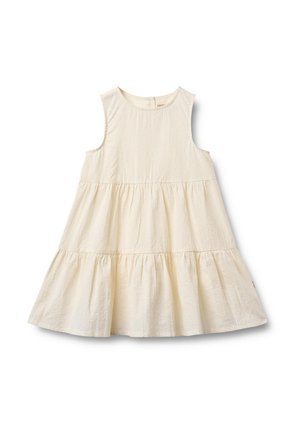 Ermeløs kremfarget kjole med lag på lag, rund halslinning og rynkede tekstildeler som skaper en utsvingt silhuett.