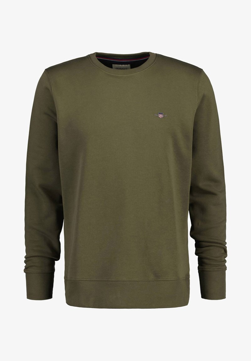 Olivenfarget sweatshirt med lange ermer, ribbestrikkede mansjetter og rund hals. Har en liten brodert logo på brystet.