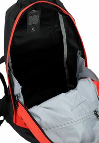 Mochila negra y naranja con una gran abertura, que cuenta con un bolsillo interior gris y detalles en cremallera. Material suave y diseño estructurado.