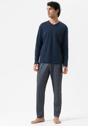 Navy long-sleeve V-neck shirt, paired with patterned pajama pants featuring a geometric design in blue and white. Soft, lightweight fabric.