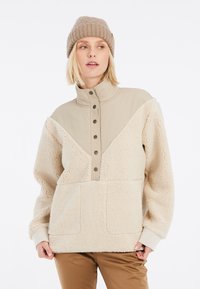 Fleece pullover in crème met een tan-kleurige kraag en knoopsluiting. Voorzien van een kangaroo pocket en een gestructureerde stof voor warmte.