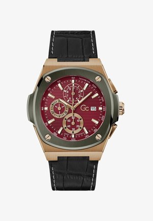 Krónográf óra bordó számlappal, arany kiemelésekkel, ezüst mutatókkal és fekete bőrszíjjal. Három segédszámlap és tachiméter skála található rajta.