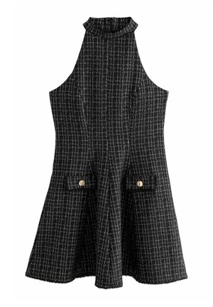 Sleeveless black and white checked dress with a high neckline, two front flap pockets with gold buttons, and an A-line skirt.