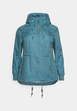 Türkise Damenjacke mit Kapuze und weißen Punkten, Frontreißverschluss, verstellbaren Kordeln an Kapuze und Saum sowie Pattentaschen mit Knöpfen.