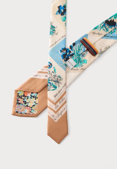 Cravate en soie avec des motifs floraux beige, bleu et vert, texte manuscrit et une boucle rayée multicolore sur fond blanc.