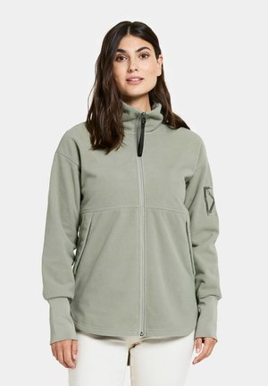 Hellgrüne Fleecejacke mit hohem Kragen, Frontreißverschluss und langen Ärmeln. Besitzt ein Logo auf dem linken Ärmel. Weiche Textur.