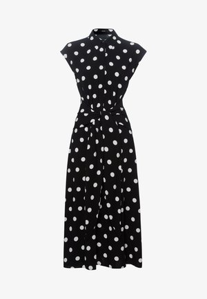 Robe midi noire sans manches à pois blancs, avec col, boutons sur le devant et ceinture nouée à la taille.