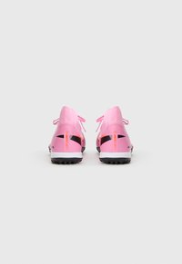 Pink athletic shoes with black accents, featuring a sleek design, textured fabric upper, and a contrasting heel tab with “Mercurial” branding.