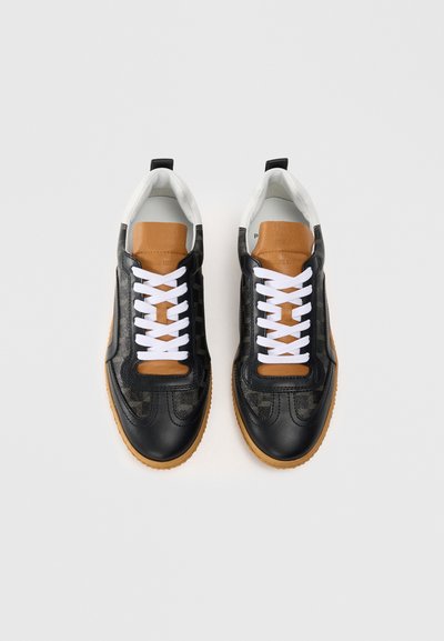 Schwarze und beigefarbene Ledersneaker mit weißen Schnürsenkeln, runder Spitze, strukturiertem Muster an den Seiten und einer Gummisohle. Draufsicht.